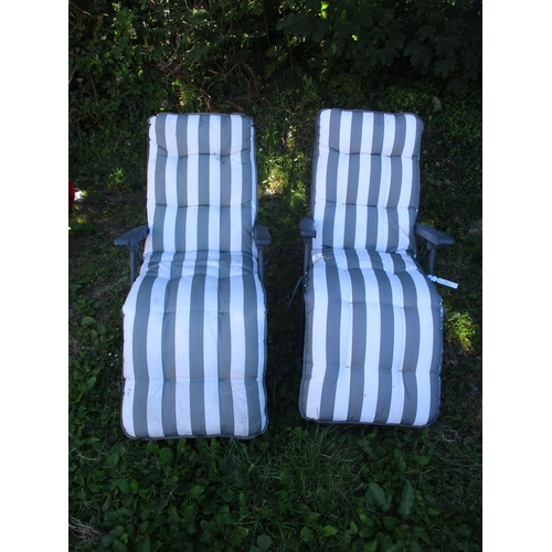 27 - A pair of folding garden chairs complete with cushions