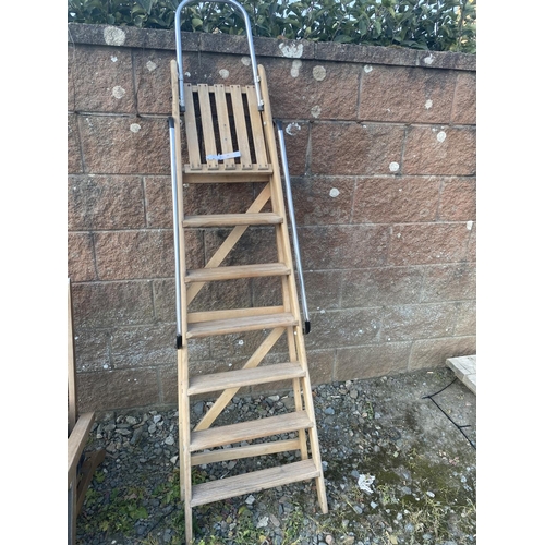 35 - A hard wood seven tread step ladder fitted chrome hand rails