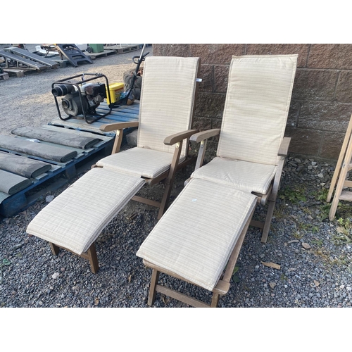 36 - A pair of teak steamer chairs complete with cushions