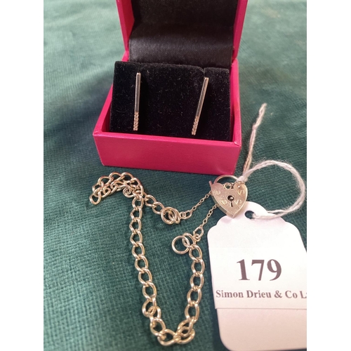 179 - A pair of silver and diamond earrings together with a silver bracelet fitted a padlock