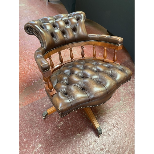 272 - A mahogany revolving study chair upholstered in brown button back leather