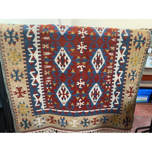 309 - A kilim floor rug with geometric designs