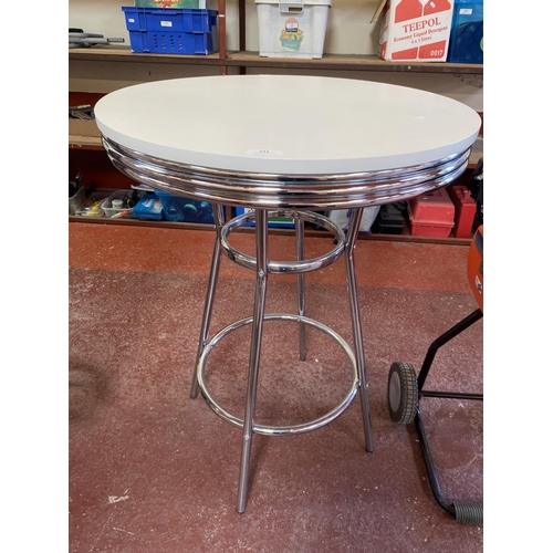 311 - A chrome framed and white finished breakfast table