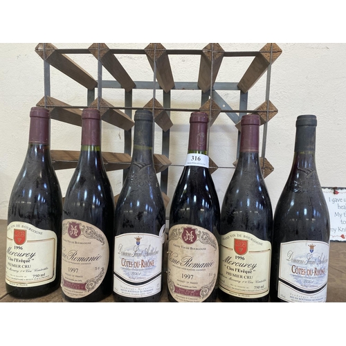 316 - Six bottles of classic French red wines together with a wine rack