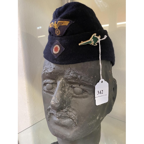 342 - A World War II German Kriegsmarine side cap with inner marking and flotilla badge (bust not included... 