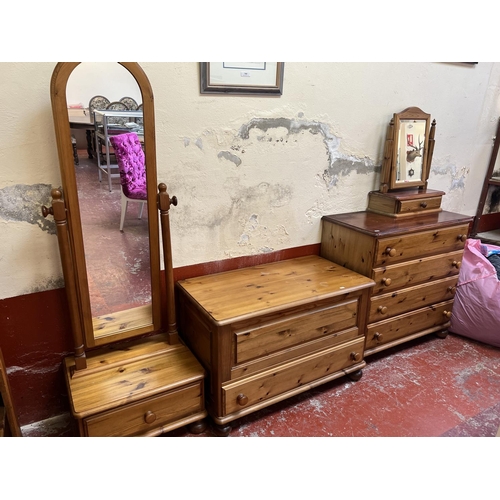 411 - A suite of honey glazed pine furniture to include a cheval mirror, a table mirror, a chest of four l... 