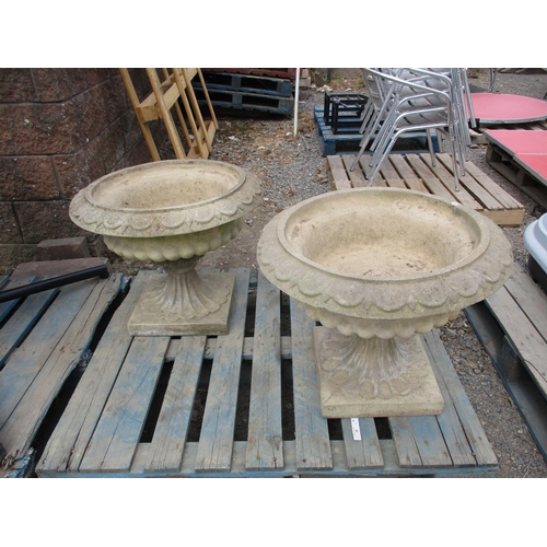 46 - A pair of reconstituted stone circular stemmed garden urns