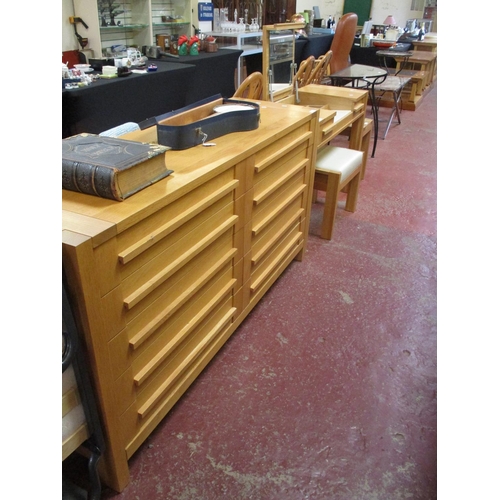 313 - A contemporary oak bedroom suite comprising of a chest of ten short drawers, a dressing table & stoo... 