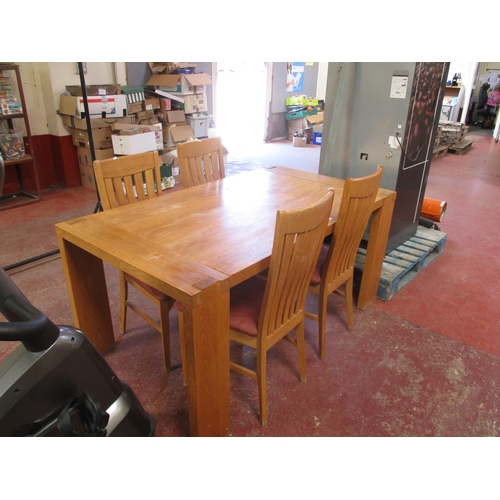 227 - A contemporary solid oak dining table together with four matching chairs