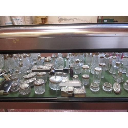 247 - An enormous collection of nineteenth century and other silver mounted perfume and powder bottles, dr... 