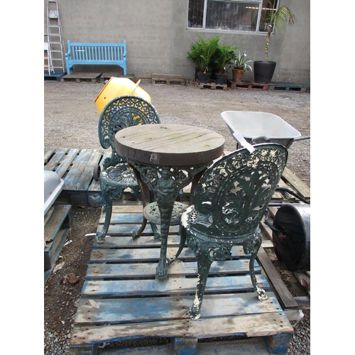 67 - A green metallic table with wooden top together with two chairs