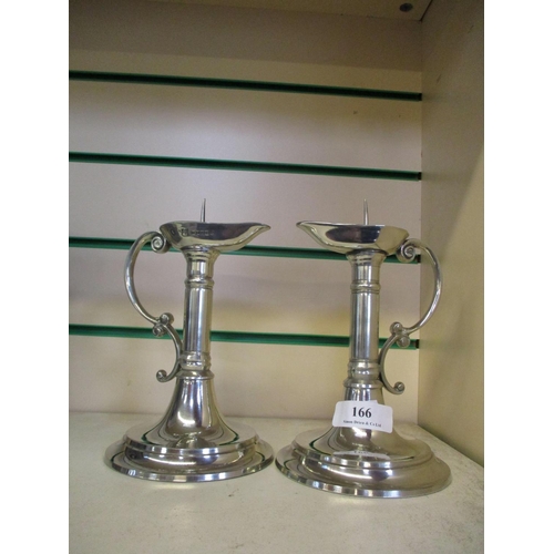 166 - A pair of pewter candle sticks of unusual form