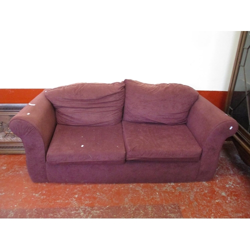 186 - A two seater sofa bed upholstered in purple