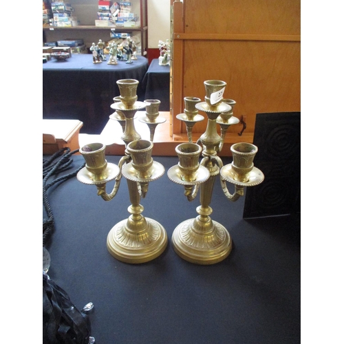 228 - Two pairs of brass candelabra