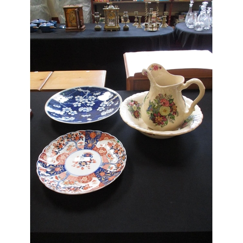 233 - Two oriental plates together with a jug and bowl set