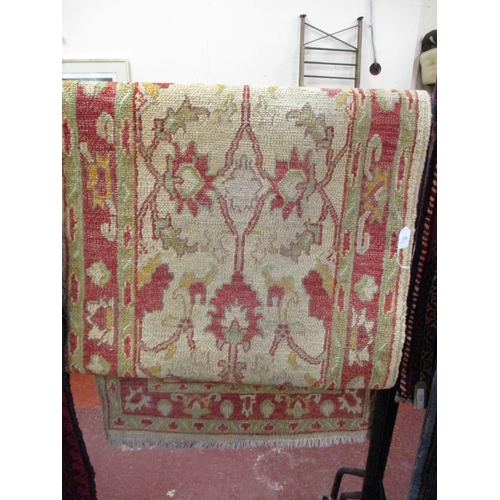 274 - A floor rug on red and beige ground with floral design