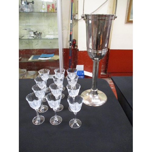 281 - A stainless steel champagne bottle holder together with twelve wine glasses