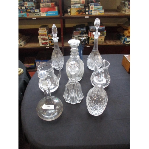 291 - A quantity of glass decanters and jugs together with a Denby jug