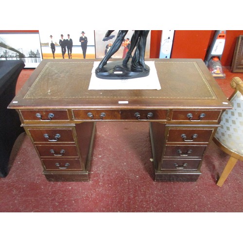 191 - A twin pedestal desk the top inlaid with tooled and gilded leather