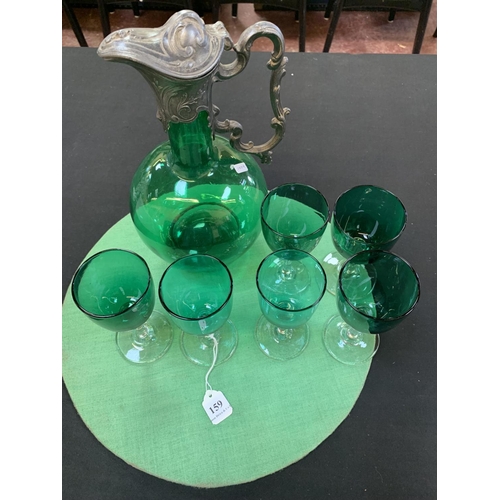 159 - A green glass ewer with pewter mounts together with six similar wine glasses