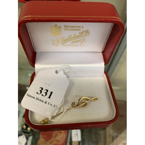 331 - A 9 carat gold and diamond treble clef pendant