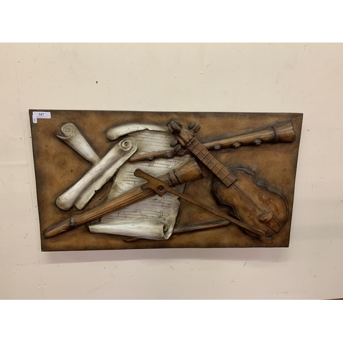 347 - A piece of wall art depicting musical instruments and manuscript