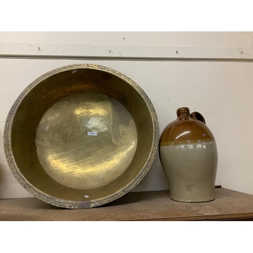 355 - A large nineteenth century brass bachin together with a salt glazed stone ware flagon