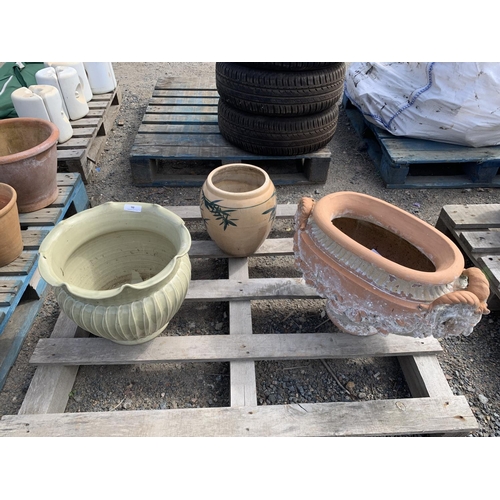 90 - A terracotta stemmed planter with rams head decoration, a salt glazed stoneware planter together wit... 