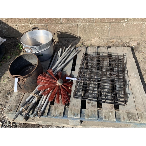 50 - A vintage cast iron cauldron, two preserving pans, a set of chimney brushes and a folding pet cage