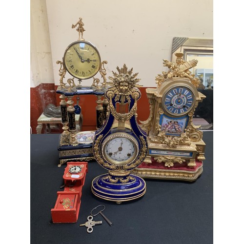 314 - Three ornate mantle clocks together with a miniature long case clock