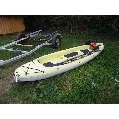 29 - A two person ocean kayak complete with paddles and trolley