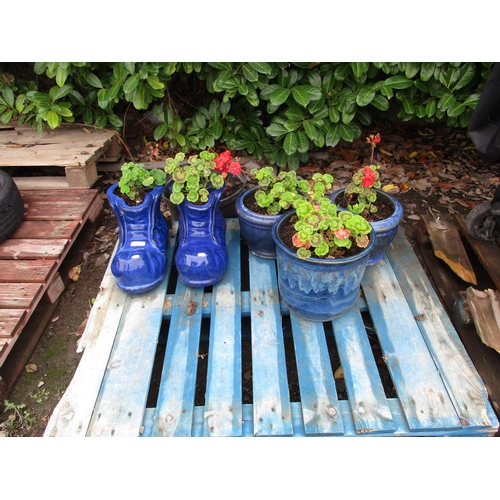 65 - A pair of blue salt glazed stone ware planters modelled in the form of boots together with three sim... 