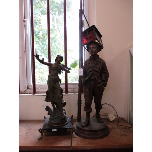 149 - A spelter table lamp modelled in the form of a street lamp and boy together with a French spelter mo... 