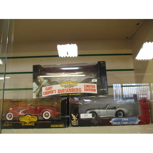 213 - Three mint boxed 1/18th scale model saloon and sports cars