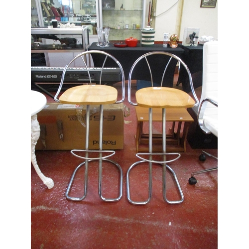 287 - A pair of wooden seated chrome breakfast stools