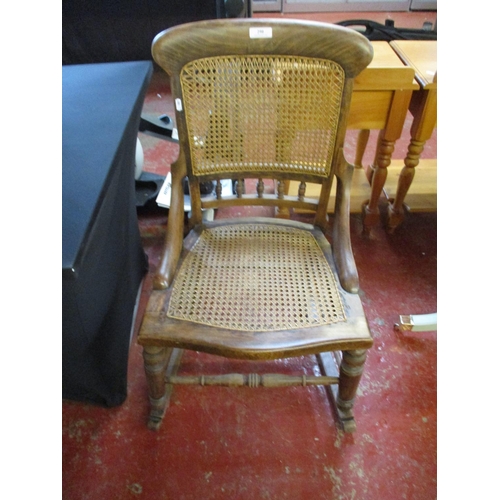 290 - A vintage mahogany and cane rocking chair