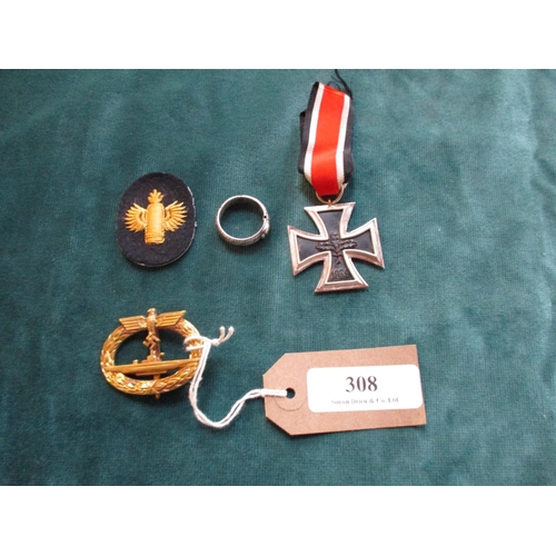 308 - A German World War II Iron Cross, a gold submarine badge, a ring and a coastal artillery patch