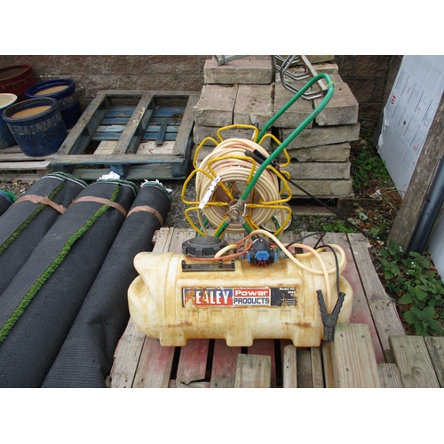 24 - A Sealey sprayer tank fitted a 12 volt pump together with a hose, reel and lance