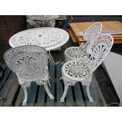 34 - A circular pierced aluminium patio table together with three matching chairs