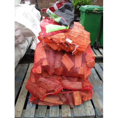 90 - Six bags of seasoned logs together with a bag of kindling wood