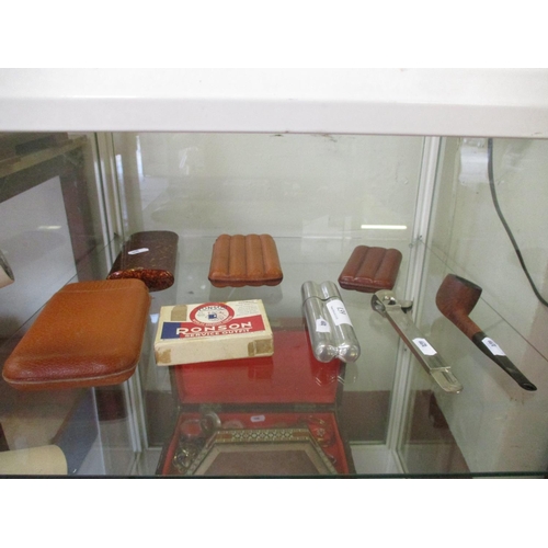 139 - Several cigar cases, a Ronson service outfit, a cigar cutter, a pipe, cigarette holders etc.