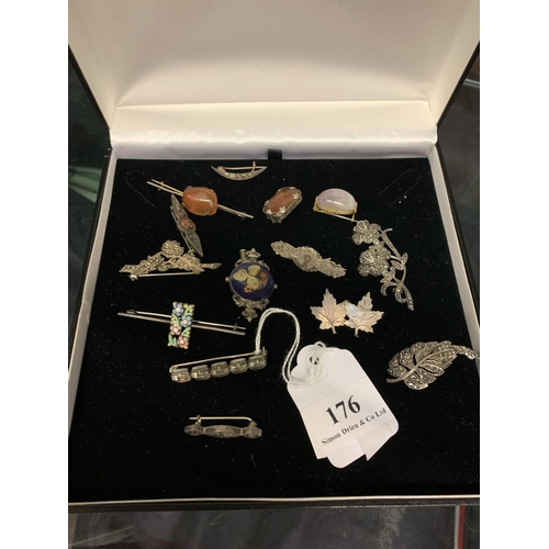 176 - A box of silver and costume jewellery brooches