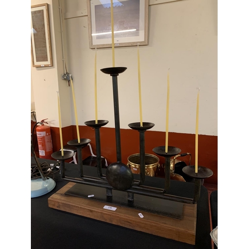 230 - A seven branch candelabra mounted upon a wooden plinth