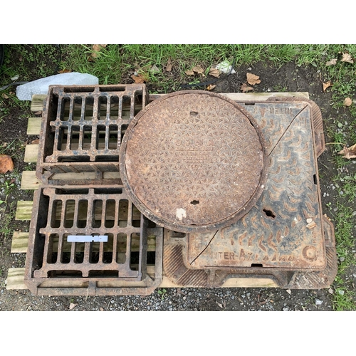 29 - Two cast iron manhole covers and frames together with two cast iron drain covers and frames