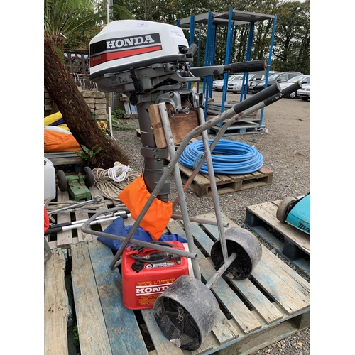 45 - A Honda 5hp four stroke outboard engine complete with Honda fuel tank and wheeled trolley