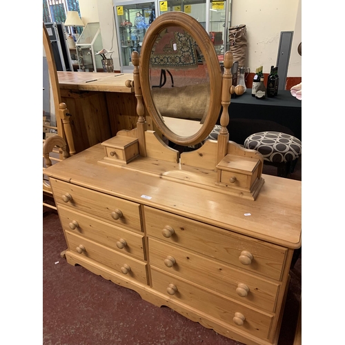 317 - A waxed pine chest of six short drawers together with an oval swivel mirror