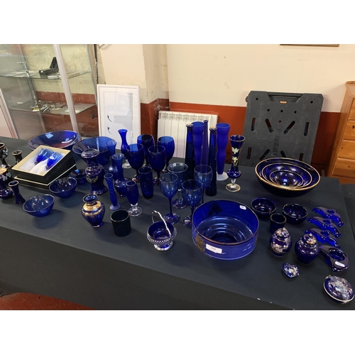 328 - A large and varied accumulation of blue glass ware and ceramics