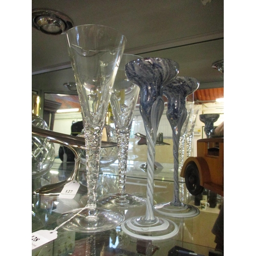 128 - A pair of Stuart Crystal Jasper Conran champagne flutes together with a pair of mottled glass candle... 