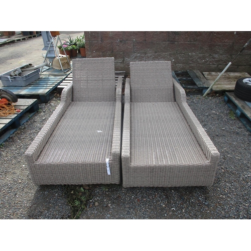 22 - A pair of all weather rattan adjustable sun loungers