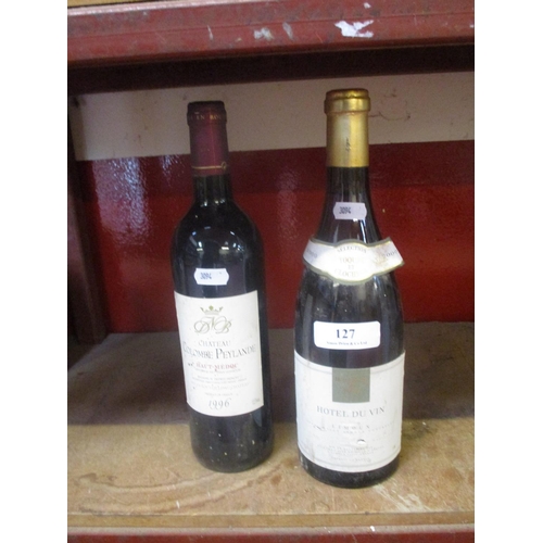 127 - A bottle of red wine together with a bottle of white wine